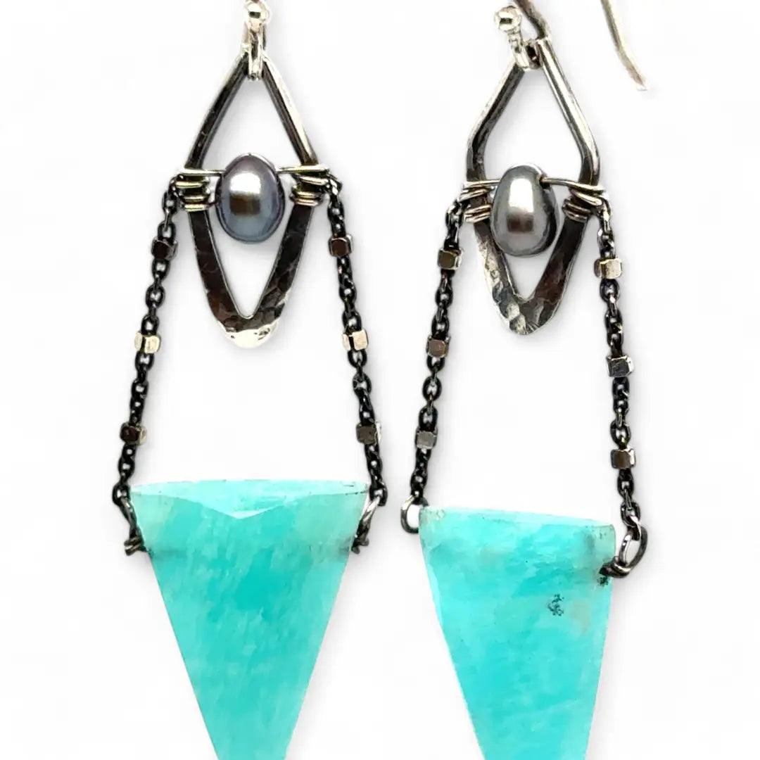 A pair of mini darkened diamonds with fresh water pearls with oxidized sterling silver dot chain holding a  a bright turquoise triangular gemstone earring