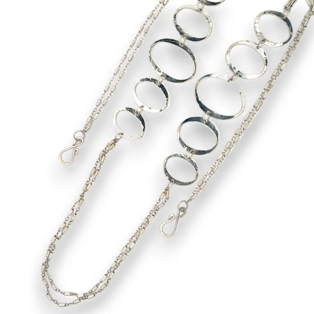 Handmade hammered large oval links held together with delicate sterling silver barrel tube chain to form long necklace that can be worn at any length