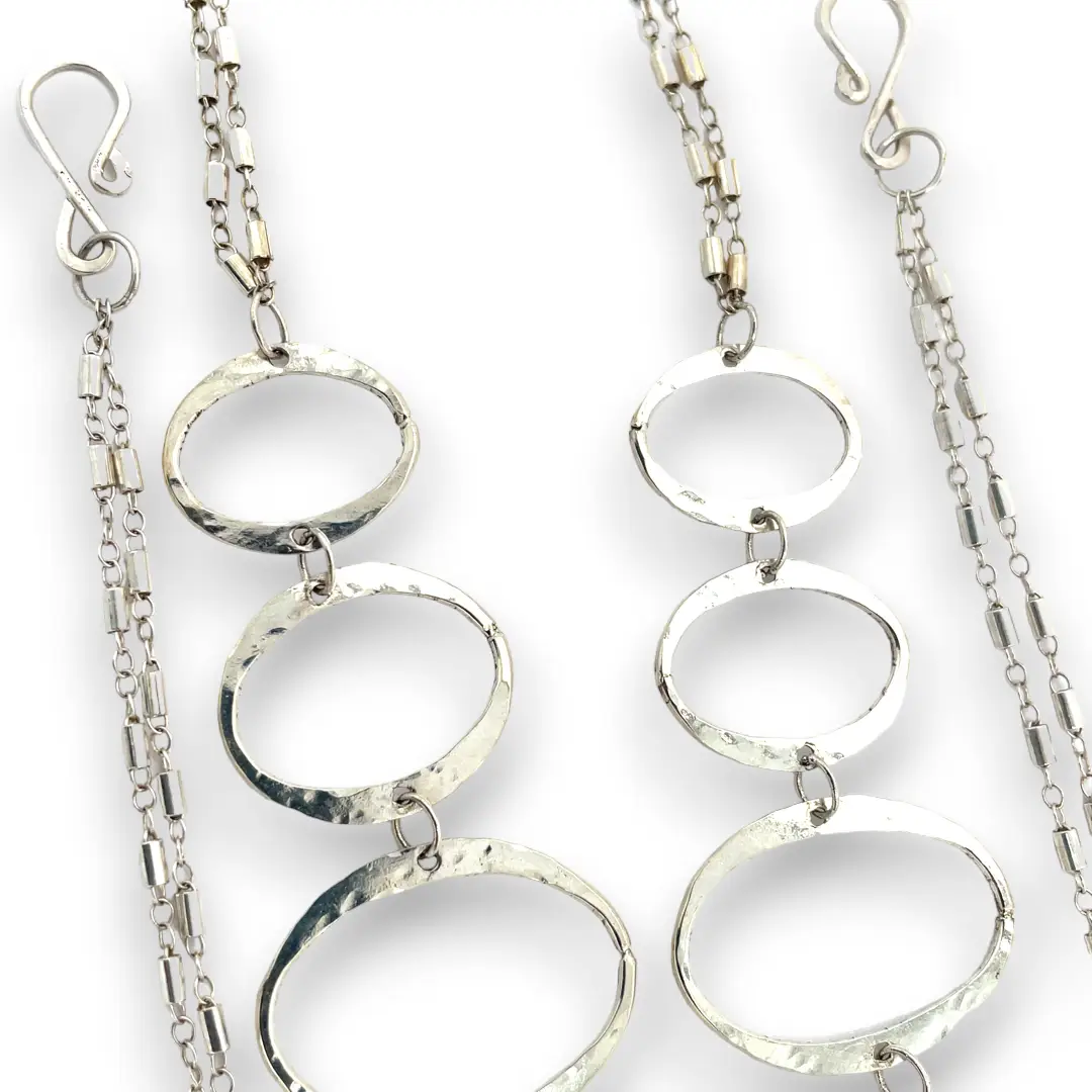 Handmade hammered large oval links held together with delicate sterling silver barrel tube chain to form long necklace that can be worn at any length