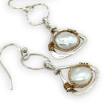 Tiny sterling silver hammered triangles hanging from a textured sterling silver ring with a fresh water pearl wrapped in twisted brass wire earrings