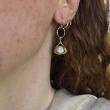 Tiny sterling silver hammered triangles hanging from a textured sterling silver ring with a fresh water pearl wrapped in twisted brass wire earrings