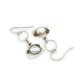 Tiny sterling silver hammered triangles hanging from a textured sterling silver ring with a fresh water pearl wrapped in twisted brass wire earrings