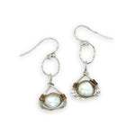 Tiny sterling silver hammered triangles hanging from a textured sterling silver ring with a fresh water pearl wrapped in twisted brass wire earrings