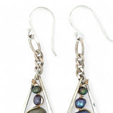 A pair of sterling silver teardrop earrings hang from curb link chain with blue/purple fresh water pearls and sodalite gemstone accents