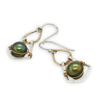 Pair of earrings with green pearls and gold and silver wirework on a white background