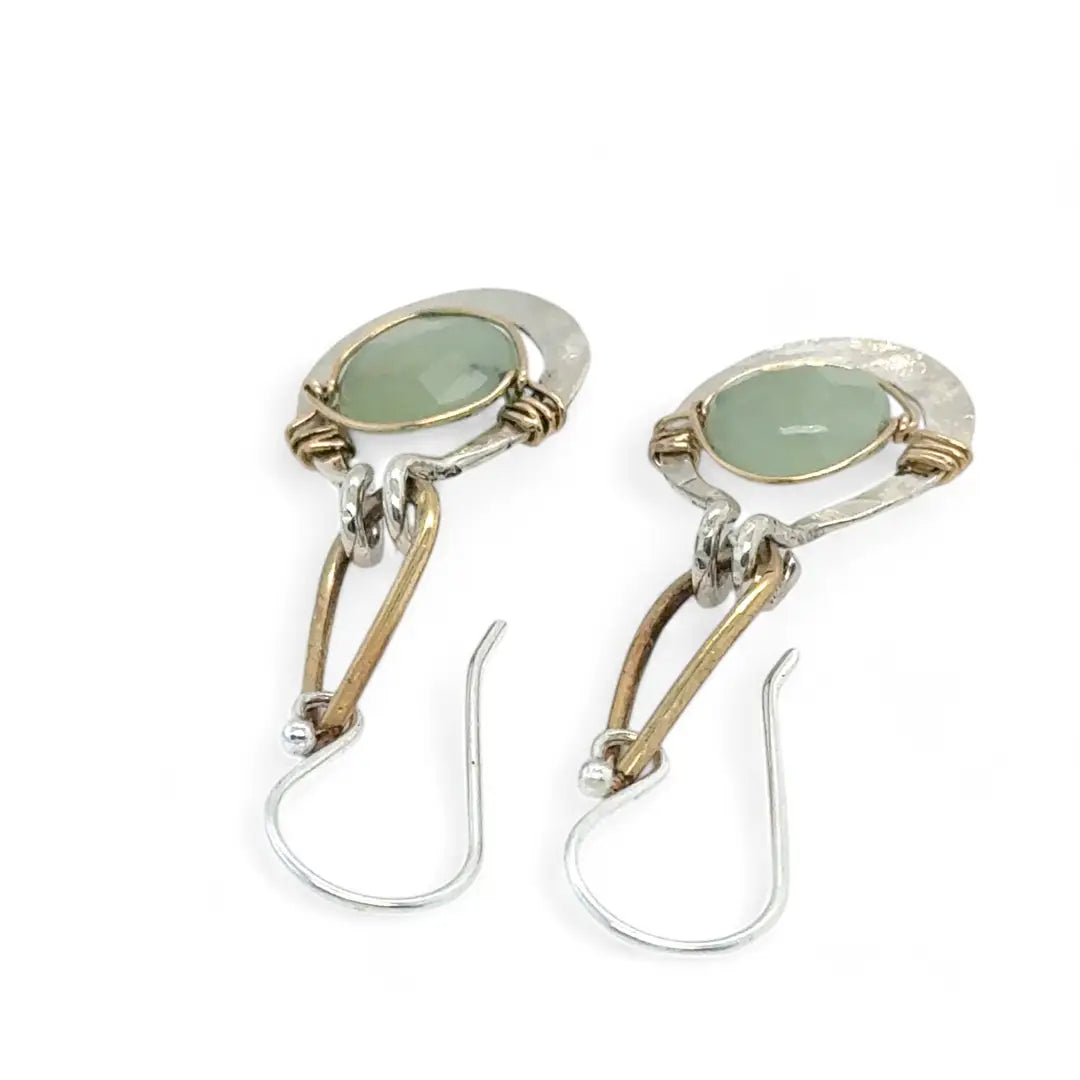 Pair of earrings with green jade gemstones on a white background