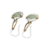 Pair of earrings with green jade gemstones on a white background