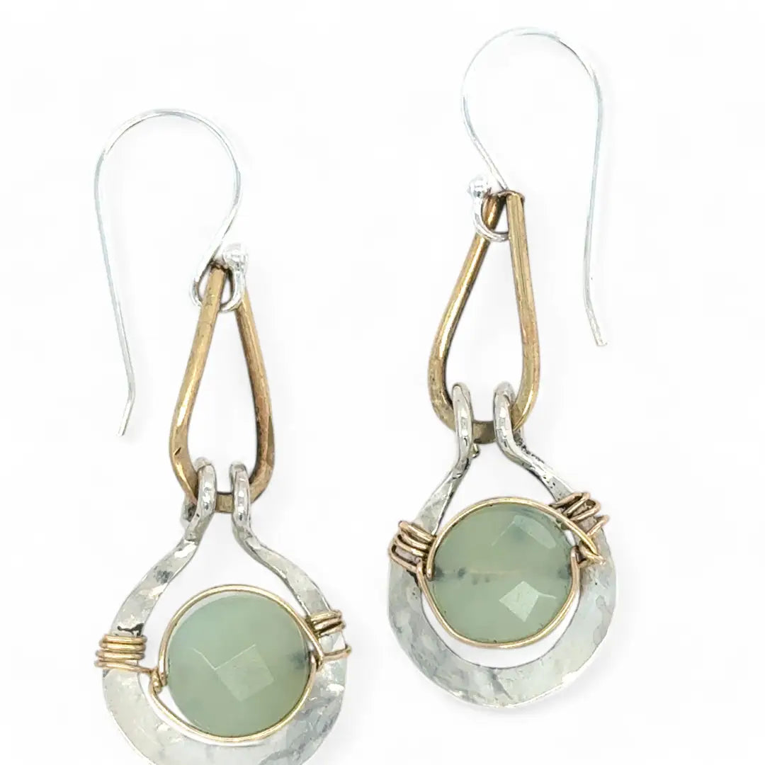 Pair of earrings with green jade gemstones and gold accents on a white background