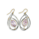 Teardrop-shaped earrings with purple stones and gold accents on a white background