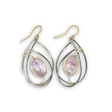 Teardrop-shaped earrings with purple stones and gold accents on a white background