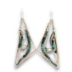 A pair of handmade geometric dangle earrings featuring gold and silver wire frames, clear glass channels, and strands of green and blue beads, shown against a plain white background.