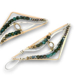 A pair of geometric dangle earrings with gold-tone triangular frames, clear resin inlays, and rows of faceted green and brown beads, shown on a white background.