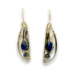 A pair of gold teardrop dangle earrings featuring deep blue lapis lazuli stones, small dark green beads, and polished gray beads, set against a plain white background.