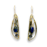A pair of gold teardrop dangle earrings featuring deep blue lapis lazuli stones, small dark green beads, and polished gray beads, set against a plain white background.
