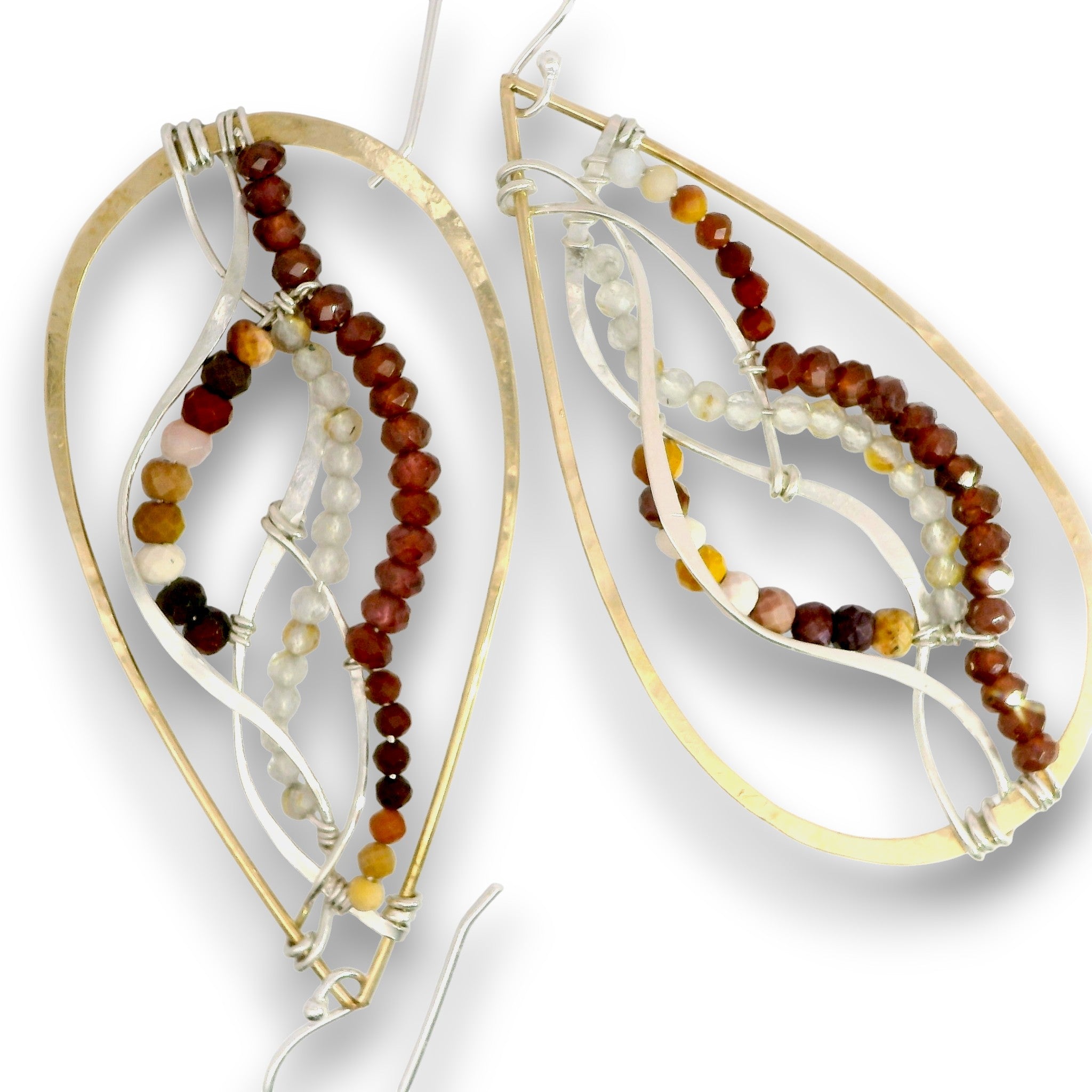 A pair of large teardrop-shaped earrings with gold-tone outer frames, layered silver-tone wire, and strands of small beads in brown, reddish-brown, cream, and amber tones, shown on a white background.