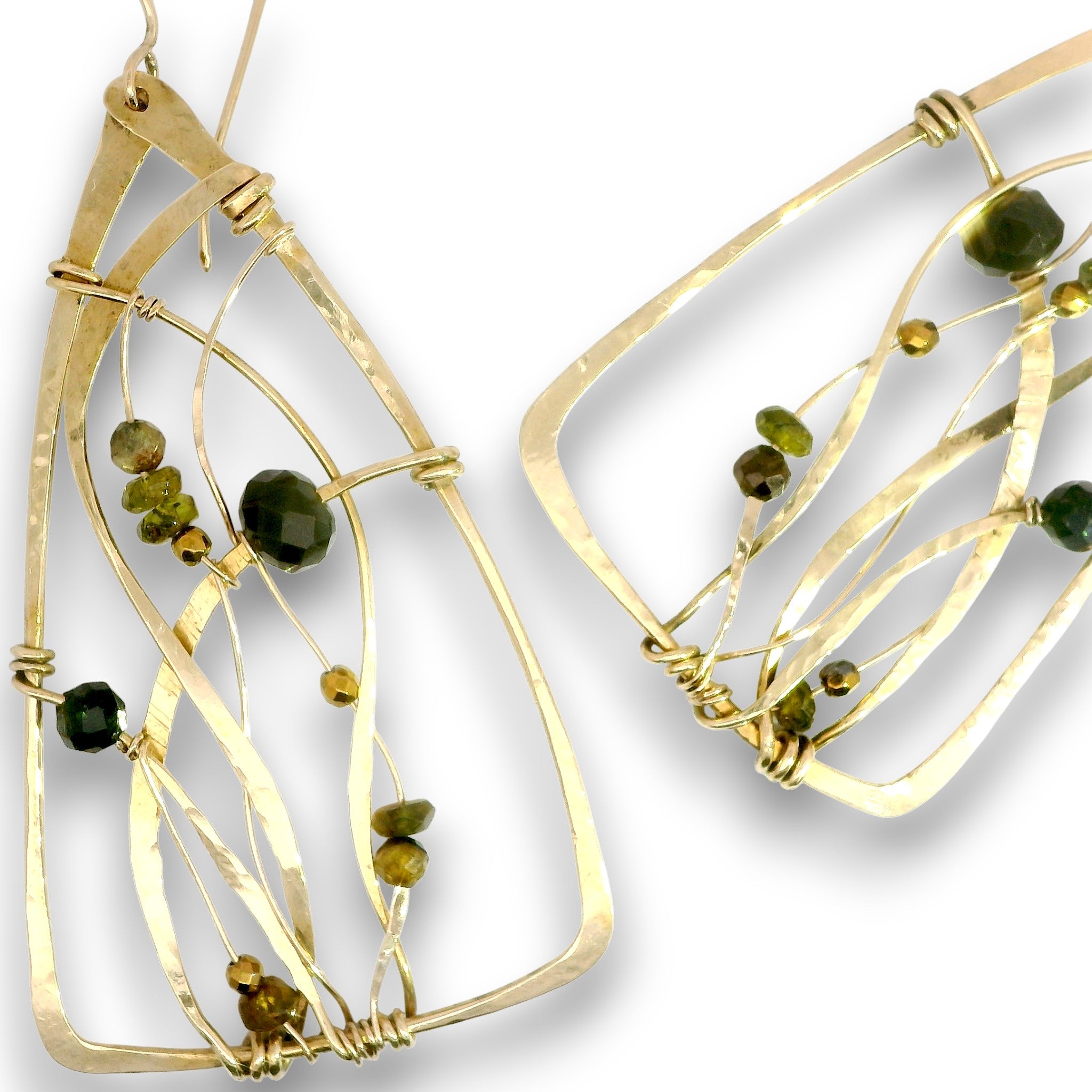 Gold-toned geometric dangle earrings with twisted wire lines and small dark green faceted beads, shown on a white background.
