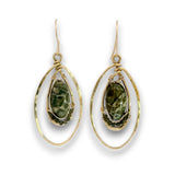 A pair of gold drop earrings featuring organic-shaped gold wire frames and oval hoops, each holding a teardrop-shaped green marbled stone, shown on a white background.