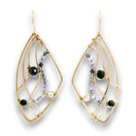 A pair of gold wireframe dangle earrings with black and gray gemstone accents, displayed on a clean white background.