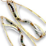 Gold and silver hoop earrings with beaded strands of natural multicolor stones, shown on a white background.