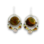A pair of silver dangle earrings featuring large round brown and green tiger's eye beads, accented with small translucent beads in yellow, green, and peach, set against a plain white background.