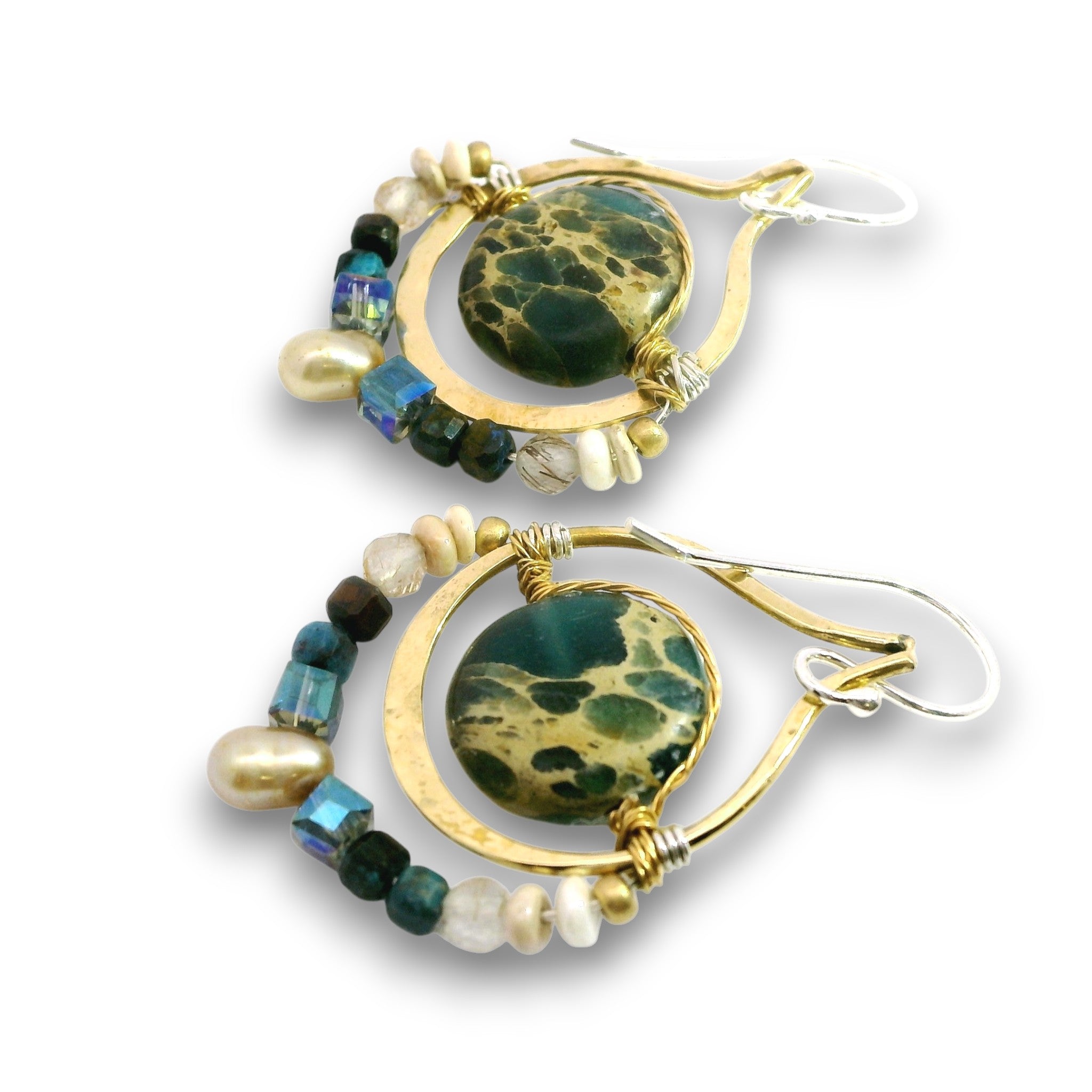 A pair of handmade dangle earrings featuring round green and black marbled stone centers, gold-tone crescent-shaped wire frames, and beaded strands with pearls, beads, and iridescent accents, shown on a white background.
