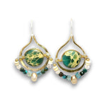 A pair of gold-tone dangle earrings featuring oval green and black marbled stone centers, accented with small beads in turquoise, cream, and dark green on a white background.