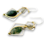 A pair of geometric dangle earrings featuring green stone inlays set in silver-toned metal with gold-toned wire wrapping and small gray stone accents, shown on a plain white background.