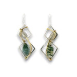 A pair of handmade dangle earrings featuring green agate stones set in a geometric design with gold and silver wire wrapping, shown on a plain white background.
