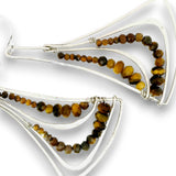 Silver geometric dangle earrings with faceted tiger's eye beads in brown, amber, and black, shown on a white background.