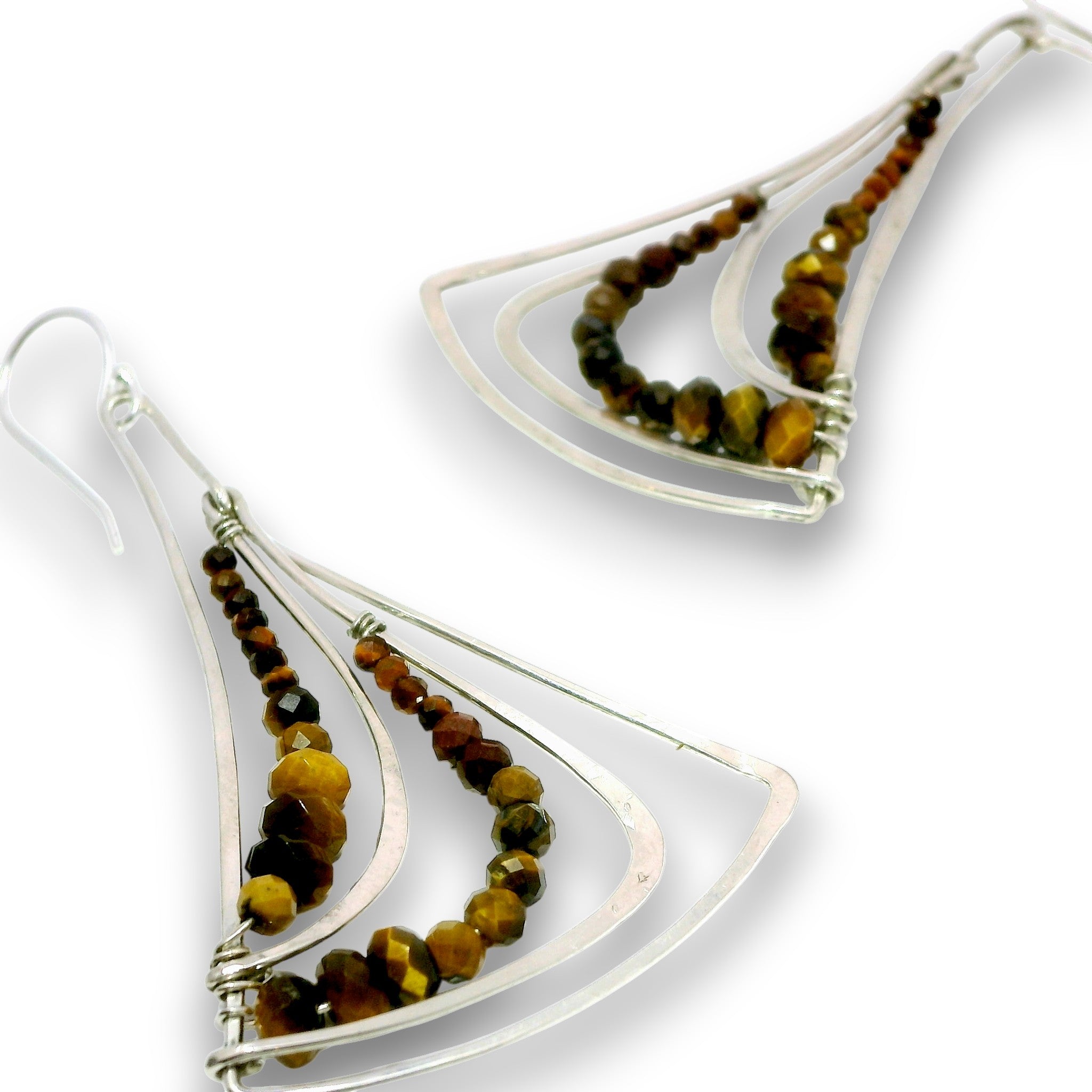 A pair of silver dangle earrings with layered triangular wire frames and rows of faceted brown, amber, and black beads, shown on a white background.