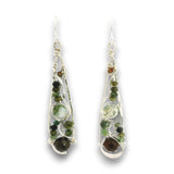 A pair of silver wire-wrapped dangle earrings featuring green and brown gemstone beads, shown against a plain white background.