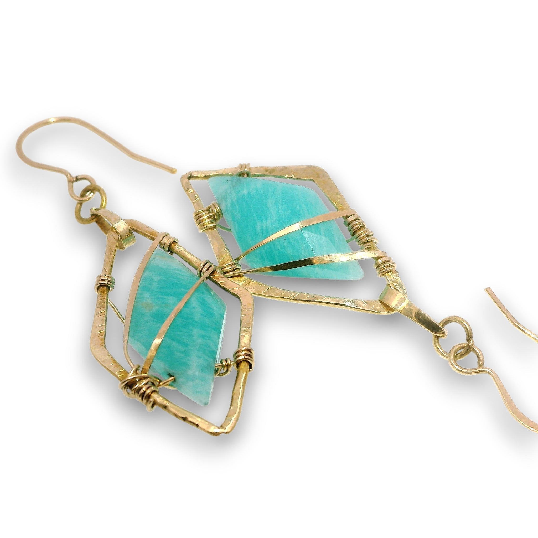 A pair of gold wire-wrapped dangle earrings featuring natural turquoise-colored amazonite stones, displayed on a clean white background.