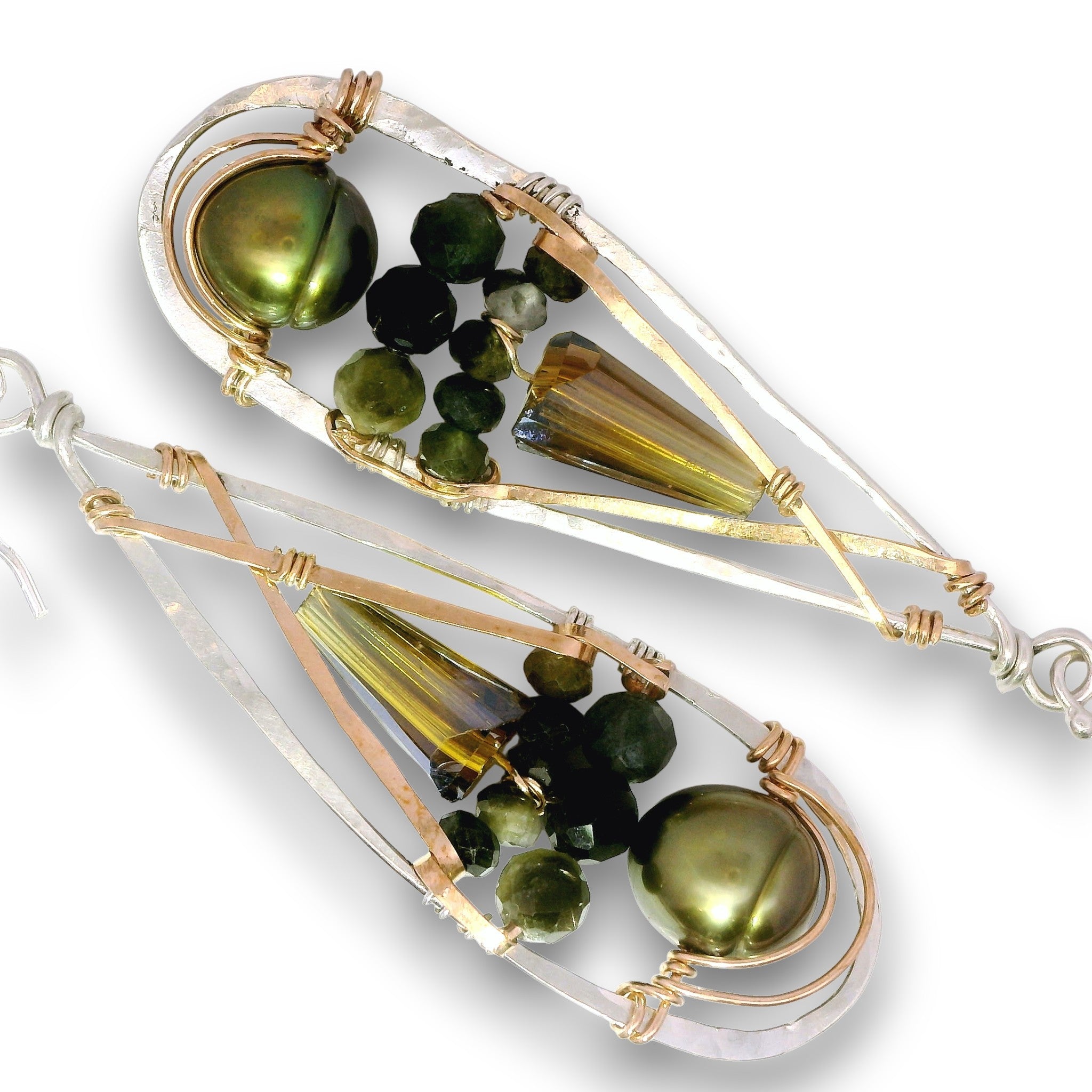 A pair of teardrop-shaped dangle earrings featuring olive green freshwater pearls, faceted amber-brown crystal drops, small dark green beads, and silver-toned and rose gold wire wrapping on a white background.