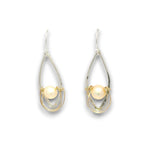 A pair of teardrop-shaped drop earrings featuring a single pearl set within a double-loop wire design, one loop in polished gold and the other in silver-tone metal, shown on a plain white background.