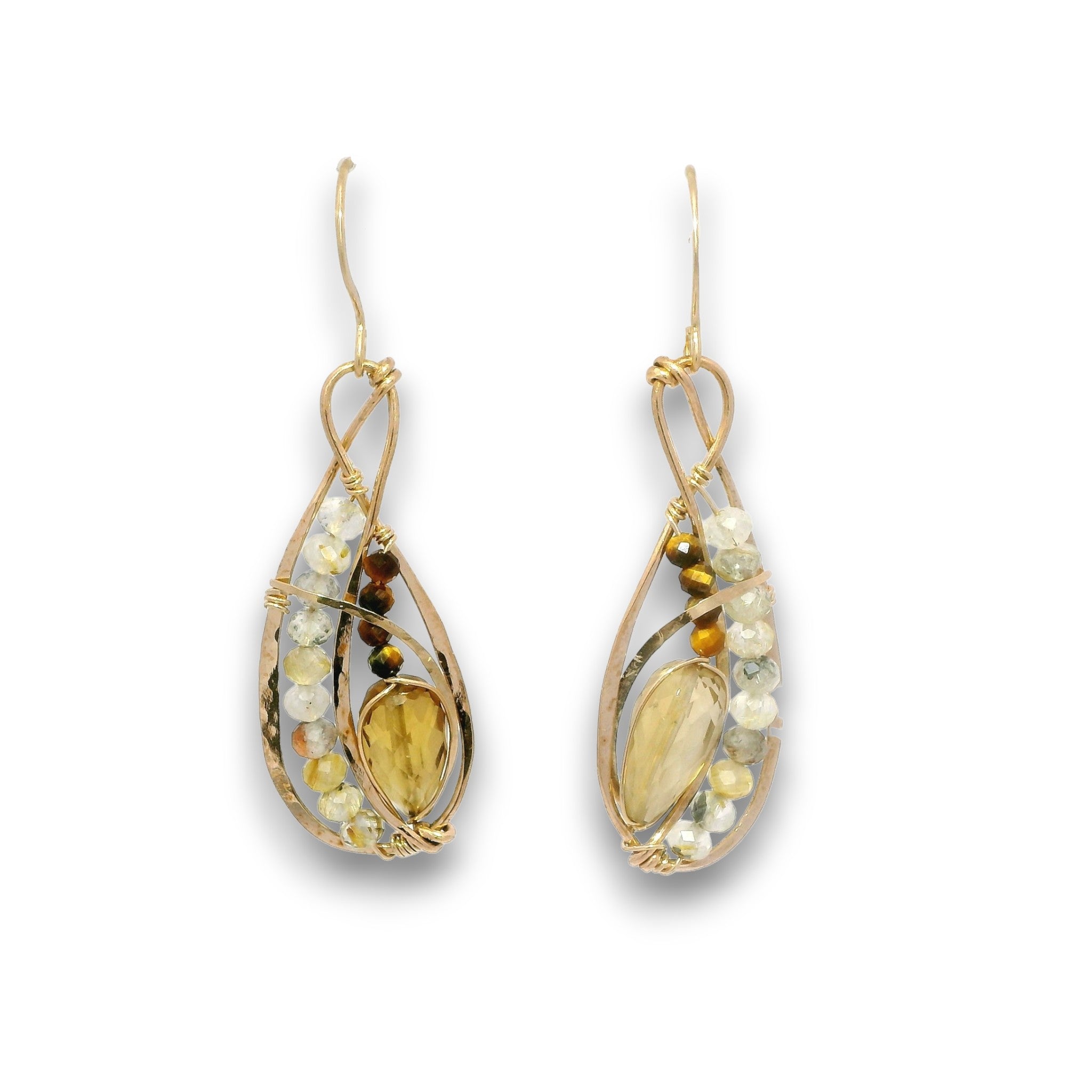 A pair of gold teardrop dangle earrings featuring a central amber-yellow stone, surrounded by small white and brown beads, on a plain white background.