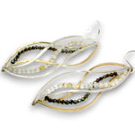 A pair of leaf-shaped dangle earrings featuring twisted gold and silver-tone metal wires, accented with strands of small faceted beads in olive green, dark brown, and milky white, shown on a plain white background.