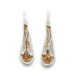A pair of teardrop-shaped dangle earrings featuring iridescent baroque pearls, wrapped in twisted copper wire with small silver beads and silver hooks, shown on a white background.