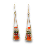 A pair of gold-toned dangle earrings with a triangular wire-wrapped design, featuring orange and red stones, small green beads, and clear rhinestones on a white background.