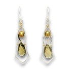 A pair of dangle earrings featuring a faceted olive-green teardrop gemstone, a round gold pearl, and a gold teardrop gemstone, all set in silver and gold wirework with silver fishhook wires.