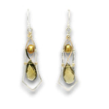 A pair of dangle earrings featuring a faceted olive-green teardrop gemstone, a round gold pearl, and a gold teardrop gemstone, all set in silver and gold wirework with silver fishhook wires.