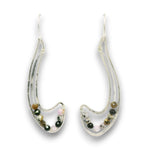 A pair of silver-toned crescent-shaped dangle earrings with small multicolored beads set inside clear resin, shown on a plain white background.