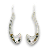 A pair of silver-toned crescent-shaped dangle earrings with small multicolored beads set inside clear resin, shown on a plain white background.