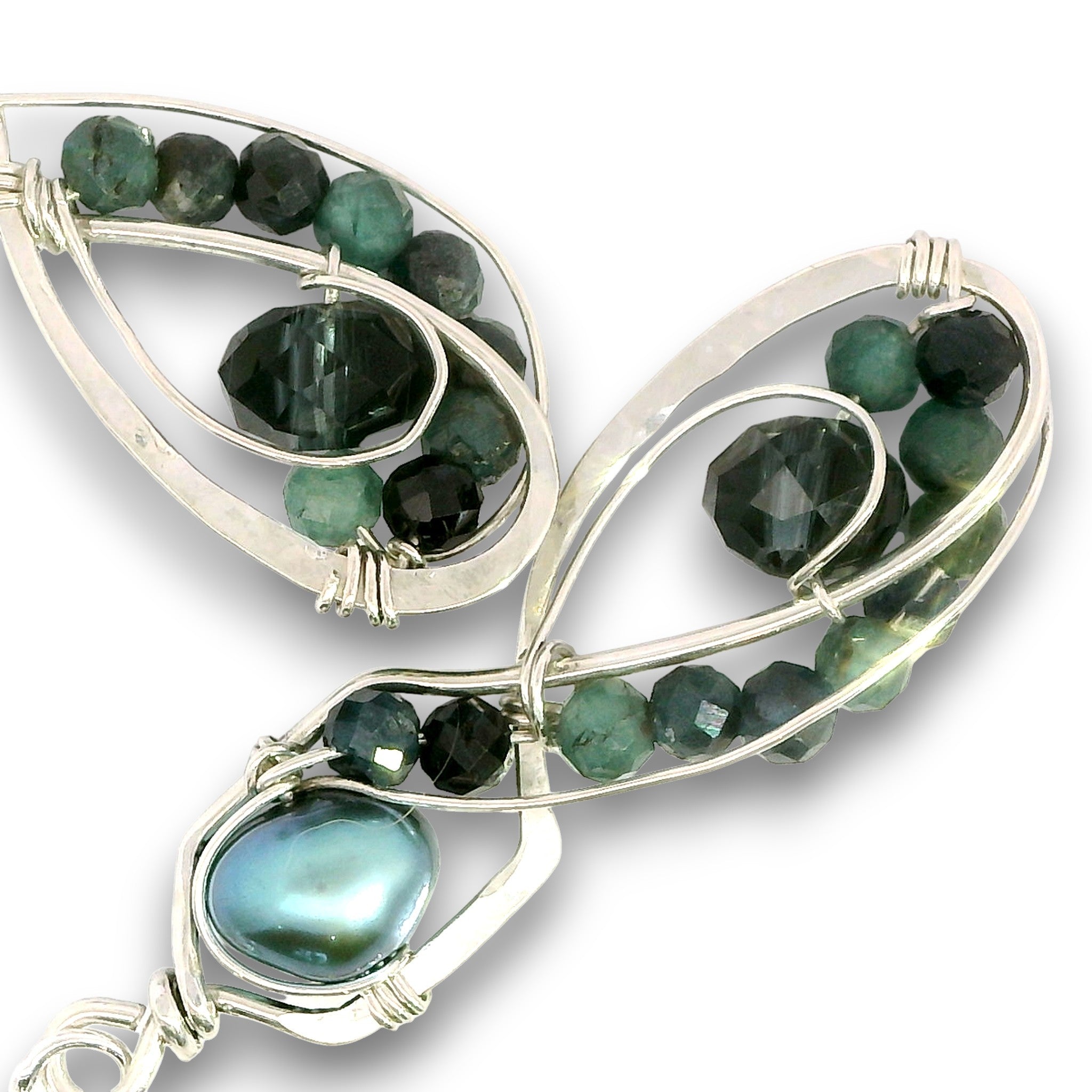 A pair of silver wire-wrapped earrings featuring faceted dark green tourmaline beads and a large iridescent green pearl, set against a plain white background.