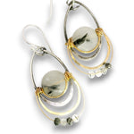 A pair of silver and gold dangle earrings featuring round gray agate stones with black inclusions, accented with small clear and gray beads on a white background.
