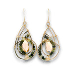 A pair of gold teardrop dangle earrings featuring faceted green beads and a central pale pinkish-gold oval stone, shown on a white background.