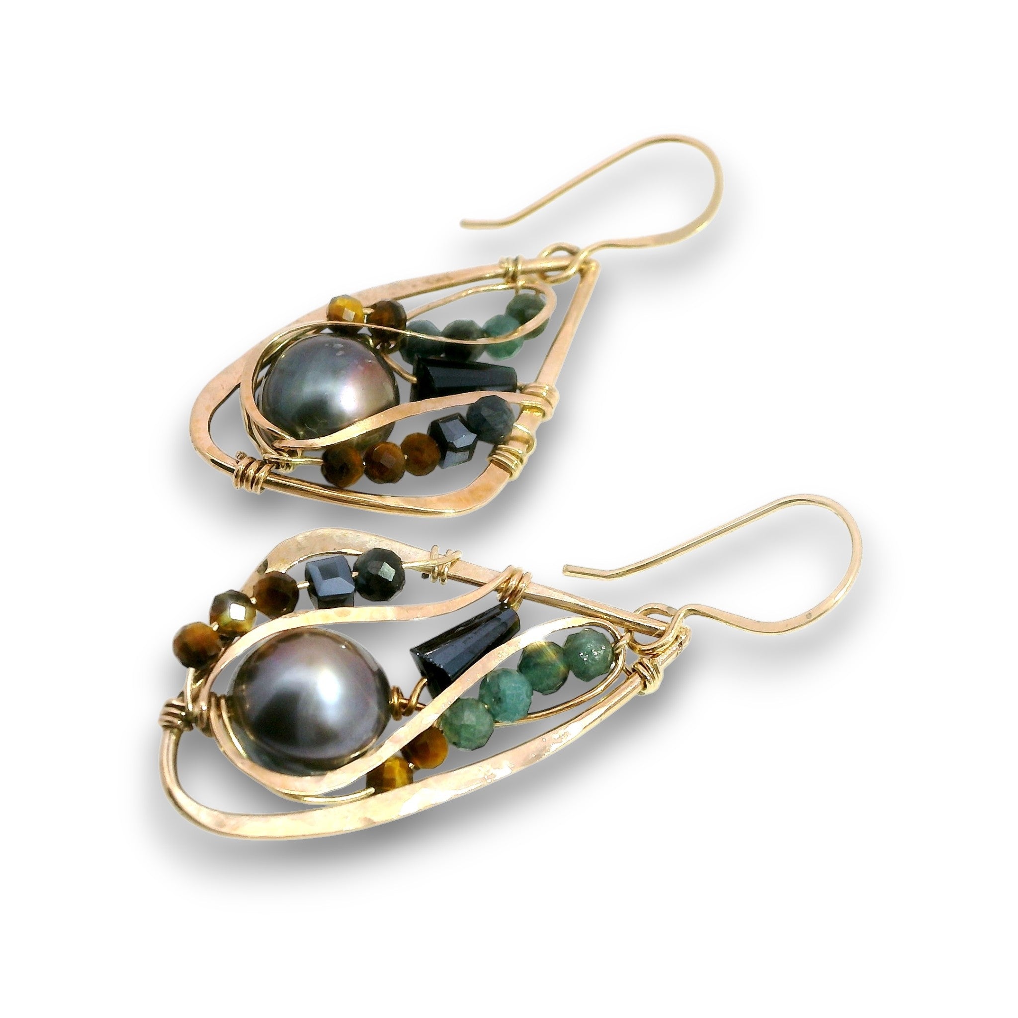 A pair of gold teardrop dangle earrings featuring a large dark gray freshwater pearl, green and brown beads, and small black faceted stones, shown on a white background.