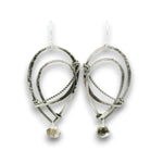A pair of handmade silver dangle earrings featuring textured hammered metal loops, twisted wire details, and small rough natural stone drops, shown against a plain white background.
