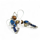 A pair of sterling silver mini diamond earrings featuring rust colored fresh water pearls, golden crystals, blue crystal drops, and lapis gemstones