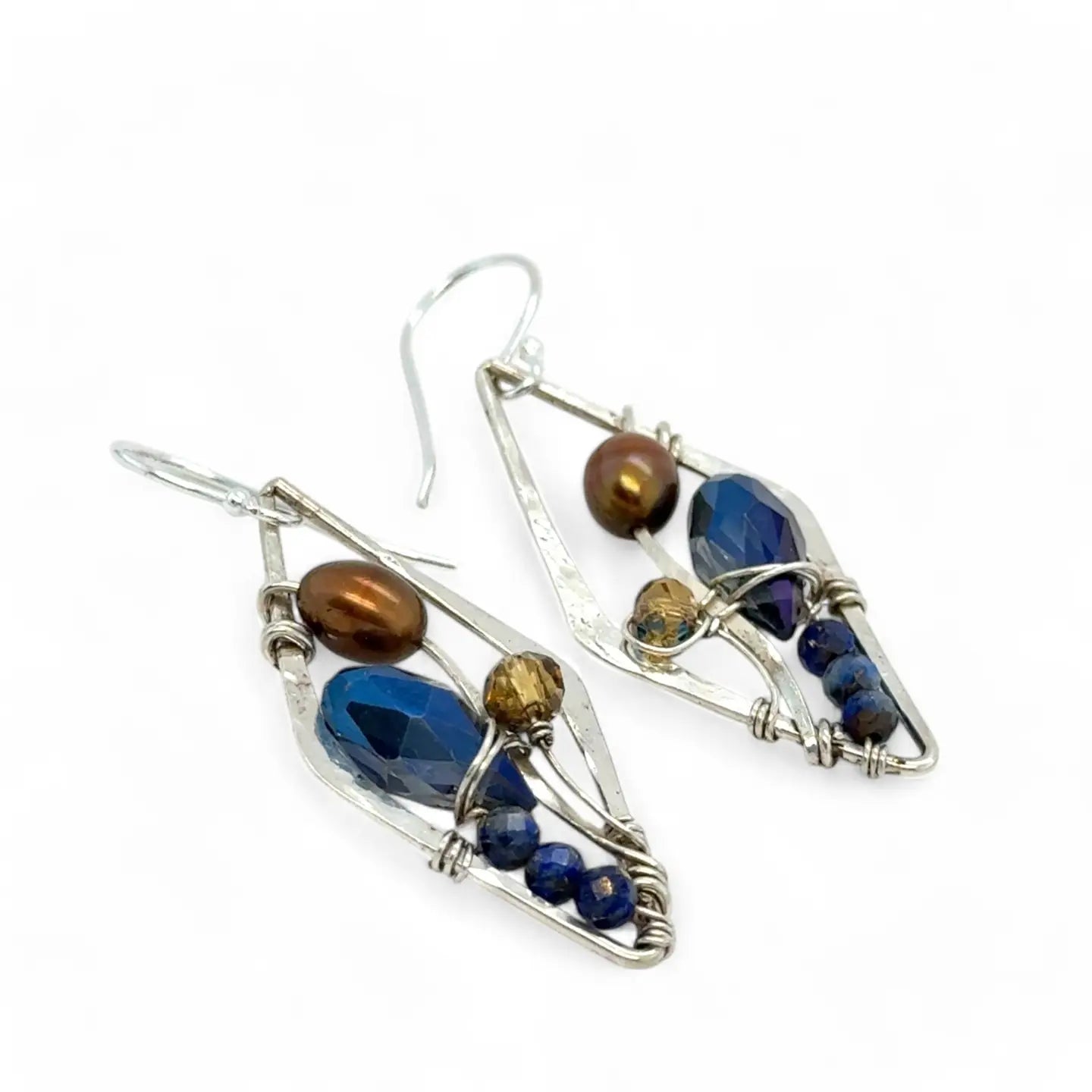 A pair of sterling silver mini diamond earrings featuring rust colored fresh water pearls, golden crystals, blue crystal drops, and lapis gemstones