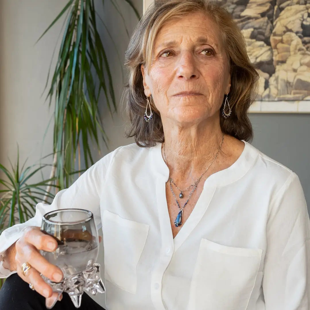 A sterling silver necklace with a handmade prong pendant featuring a deep blue sodalite natural gemstone, micro faceted sodalite and labradorite gemstones, and a lustrous gray blue fresh water pearl, connected to an oxidized link chain.